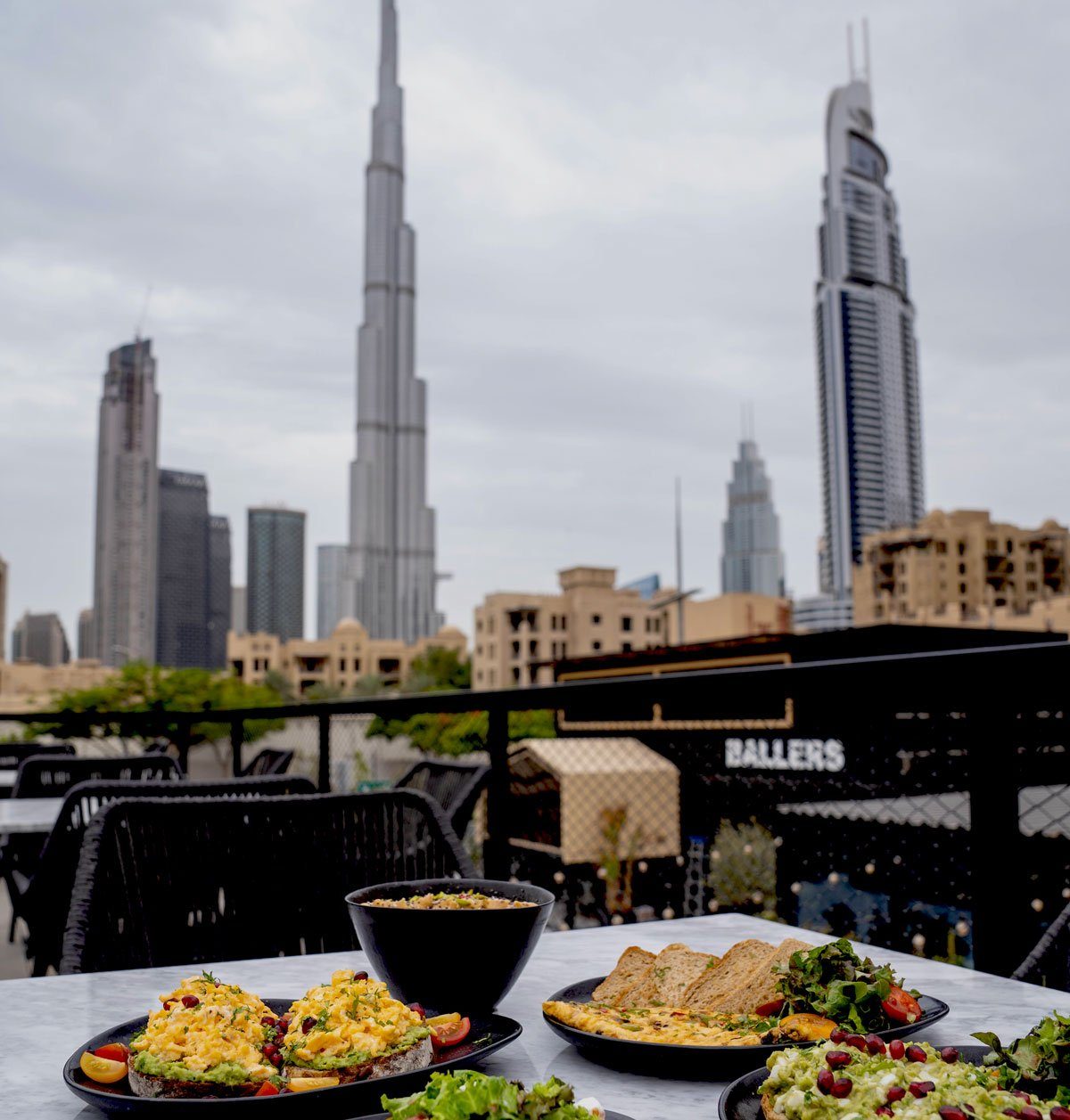Breakfast laid out on a table on the Ballers terrace, the Burj Khalifa beyond